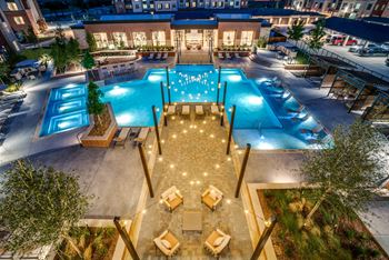Resort-style swimming pool with sunning ledge, plunge pools, cabanas, and fire pit
